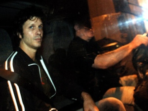 Bertrand Cantat, left, the French rock star convicted of manslaughter for beating his actress girlfriend to death, sits in a car as he is released from a prison early Tuesday, Oct. 16, 2007 near Toulouse, southwestern France. Cantat, serving an eight-year sentence for the 2003 fatal beating of 41-year-old French actress Marie Trintignant in a Vilnius hotel room, Lithuania, was released ahead of schedule based in part on his good behavior.(AP Photo/Remy Gabalda)