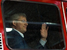 Prime Minister Stephen Harper arrives in a fire engine to an election campaign announcement at a fire hall in Victoriaville, Que., on Tuesday, April 5, 2011. (THE CANADIAN PRESS/Sean Kilpatrick)