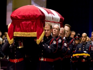 Pallbearers carry the casket of Sgt. Ryan Russell during his funeral in Toronto on Tuesday, January 18, 2011. Thousands honoured Sgt. Russell who was killed by a stolen snowplow on January 12 in Toronto. (THE CANADIAN PRESS/Chris Young)