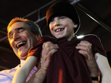 Liberal leader Michael Ignatieff, left, lifts a young boy after speaking at a rally during a campaign stop in Drummondville, Que., on Tuesday, April 5, 2011. (THE CANADIAN PRESS/Nathan Denette)