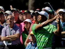 Tiger Woods watches his approach shot to the third green during the first round of the Masters golf tournament Thursday, April 7, 2011, in Augusta, Ga. (AP Photo/Chris O'Meara)