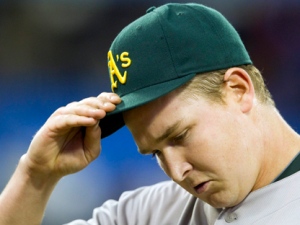 Oakland Athletics starting pitcher Trevor Cahill walks off the field after sixth inning AL action against the Toronto BLue Jays in Toronto on Thursday, April 7, 2011. (THE CANADIAN PRESS/Frank Gunn)