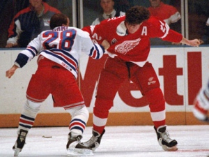 New York Rangers forward Tie Domi, left, fights with Detroit Red Wings player Bob Probert during an NHL game at New York's Madison Square Garden, Dec. 2, 1992. (AP Photo/Ron Frehm)