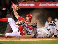 Los Angeles Angels Peter Bourjos beats the tag of Toronto Blue Jays catcher J.P. Arencibia to score the winning run in the fourteenth inning on a single by Macier Ituris during a  baseball game in Anaheim Calif., on Saturday, April 9, 2011. Los Angeles won 6-5. (AP Photo/Christine Cotter) 