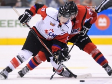 Team Orr forward Ryan Nugent-Hopkins, left, battles for the puck against Team Cherry forward Rickard Rakell, right, during third period CHL Top Prospects hockey action in Toronto on Wednesday, January 19, 2011. (THE CANADIAN PRESS/Nathan Denette)