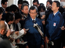 Tokyo Electric Power Co. President Masataka Shimizu, center, speaks to media at the Fukushima prefectural office a month to the day after an earthquake and tsunami struck northeastern Japan, in Fukushima, Japan, Monday, April 11, 2011. (AP Photo/Hiro Komae)