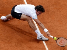 Milos Raonic of Canada plays a return to Ernest Gulbis of Latvia during their match of the Monte Carlo Tennis Masters tournament in Monaco, Tuesday, April 12, 2011. (AP Photo/Lionel Cironneau)