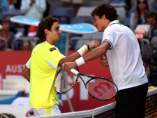 David Ferrer of Spain, left, talks with Milos Raonic of Canada at the net after winning their fourth round match at the Australian Open tennis championships in Melbourne, Australia, Monday, Jan. 24, 2011. (AP Photo/Rob Griffith)