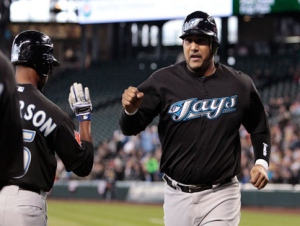 Toronto Blue Jays' Jose Molina, right, is congratulated by teammate Corey Patterson after scoring against the Seattle Mariners in the third inning of a major league baseball game on Wednesday, April 13, 2011, in Seattle. (AP Photo/Elaine Thompson)