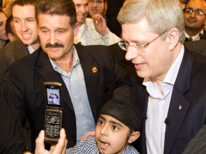 Prime Minister Stephen Harper poses for photos leaving a campaign rally in Toronto on Thursday April 14, 2011. (THE CANADIAN PRESS/Frank Gunn)