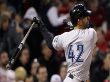 Toronto Blue Jays Jose Bautista follows through on an RBI single, which started off a four run rally for the Blue Jays, breaking a 3-3 tie in the seventh inning against the Boston Red Sox in an MLB baseball game at Fenway Park in Boston, Friday, April 15, 2011. (AP Photo/Charles Krupa)