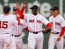 Boston Red Sox's Mike Cameron, center, and Jacoby Ellsbury, right, celebrate with teammates after beating the Toronto Blue Jays 4-1 in the ninth inning of an MLB baseball game, April 16, 2011, in Boston. (AP Photo/Michael Dwyer)