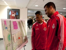 Toronto FC's captain Maicon Santos (right) and designated player Julian de Guzman look at a design presentation following a press conference in Toronto on Monday April 18, 2011 to announce the club's plans to develop a new Academy and Training facility at Downsview Park. (THE CANADIAN PRESS/Chris Young)