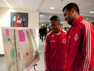 Toronto FC's captain Maicon Santos (right) and designated player Julian de Guzman look at a design presentation following a press conference in Toronto on Monday April 18, 2011 to announce the club's plans to develop a new Academy and Training facility at Downsview Park. (THE CANADIAN PRESS/Chris Young)