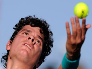 This is a Tuesday, March 15, 2011 file photo of Milos Raonic, of Canada, as tosses the ball on a serve to Ryan Harrison, of the United States, at the BNP Paribas Open tennis tournament, in Indian Wells, Calif. Milos Raonic's first appearance at the Barcelona Open will mark the closest thing to a homecoming outside of his native Canada as the rising star of men's tennis credits his climb up the rankings to a preseason move to the Catalan capital. (AP Photo/File)