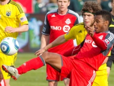 Toronto FC's Julian de Guzman, right, battles for the ball with Columbus Crew's Tom Heinemann during second half MLS action in Toronto Saturday, April 23, 2011. THE CANADIAN PRESS/Darren Calabrese