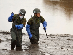 Japan Ground Self-Defense Force members search for missing people in their third major recovery operation since the March 11 earthquake in Shichigahamamachi, Miyagi Prefecture, northeastern Japan, Monday, April 25, 2011. (AP Photo/Hiro Komae)