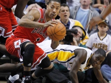 Chicago Bulls' Derrick Rose (1) grabs a loose ball in front of Indiana Pacers' Darren Collison during the first half of Game 3 of a first-round NBA basketball series in Indianapolis, Thursday, April 21, 2011. (AP Photo/Darron Cummings)