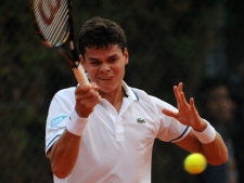 Canada's Milos Raonic returns a ball to France's Gilles Simon during his Estoril Tennis Open quarterfinals match Friday, April 29 2011, in Oeiras, outside Lisbon. (AP Photo/Paulo Duarte)