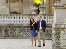 The Duke and Duchess of Cambridge walk hand in hand from Buckingham Palace in London Saturday April 30 2011, the day after their wedding. (AP Photo/ John Stillwell, pool)