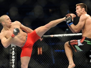 Georges St-Pierre, left, battles against Jake Shields during the welterweight championship match at UFC 129 in Toronto on Saturday, April 30, 2011. St-Pierre defeated Shields in a five-round decision to defend his welterweight title. (THE CANADIAN PRESS/Nathan Denette)