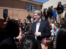 Prime Minister Stephen Harper greets children at a school after he voted in Calgary, Monday, May 2, 2011. (THE CANADIAN PRESS/Jonathan Hayward)