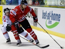 Canada's Travis Zajac, right, fights for a puck with Martin Pluss, left, from Switzerland during their preliminary round group B Hockey World Championships match in Kosice, Slovakia, Tuesday, May 3, 2011. (AP Photo/Petr David Josek)