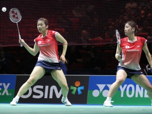 This March 11, 2011, file photo shows Japan's Reika Kakiiwa, left, hitting a shot as her partner Mizuki Fujii looks on during their women's doubles quarterfinal match against Petya Nedelcheva and Anatasia Russkikh of Bulgaria at the All England Badminton Championships in Birmingham, England. Badminton's governing body has responded to criticism it is being sexist by ordering female players to wear skirts. (AP Photo/Simon Dawson, File)