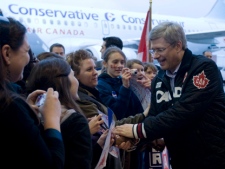 Prime Minister Stephen Harper is greeted by supporters as he arrives in Ottawa on Tuesday May 3, 2011. (THE CANADIAN PRESS/Adrian Wyld)