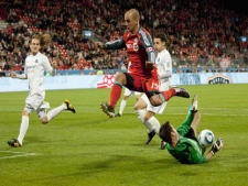 Toronto FC 's Mikael Youassowsky (centre) hurdels FC Edmonton's goalie Lance Parker (right) during second half Nutrilite Canadian Championship semi final action in Toronto on Wednesday May 4, 2011. (THE CANADIAN PRESS/Chris Young)