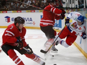 Dion Phaneuf, left, from Canada skates as his teammate Brent Burns, center, checks on board Czech Republic's Patrik Elias, right, during their friendly hockey match in Prague, Czech Republic, Wednesday, April 27, 2011. (AP Photo/Petr David Josek)