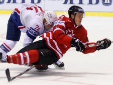 Nicolas Besch, left, from France trips Canada's Jeff Skinner, right, during their preliminary round group B Hockey World Championships match in Kosice, Slovakia, Sunday, May 1, 2011. Canada won the match 9-1. (AP Photo/Petr David Josek)