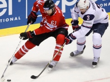 Canada's Rick Nash, left, fights for the puck with Jack Johnson of the U.S. during their qualification round group F hockey World Championships match in Kosice, Slovakia, Friday, May 6, 2011. (AP Photo/Petr David Josek)