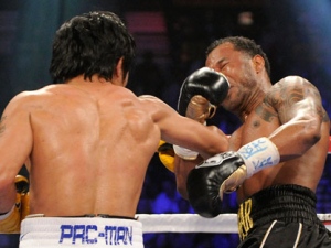 Manny Pacquiao left, lands a punch to Shane Mosley that knocked him down during the third round during a WBO welterweight title bout, Saturday, May 7, 2011, in Las Vegas.  (AP Photo/Mark Terrill)