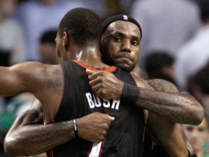 Miami Heat forward LeBron James, rear, embraces teammate Chris Bosh after the Heat's 98-90 win in overtime in Game 4 of a second-round NBA playoff basketball series in Boston, Monday, May 9, 2011. (AP Photo/Charles Krupa)
