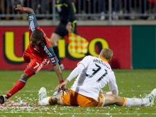 Toronto FC 's Joao Plata, left, is tackled by Houston Dynamo's Andre Hainault during second half MLS action in Toronto on Saturday May 7, 2011. (THE CANADIAN PRESS/Chris Young)