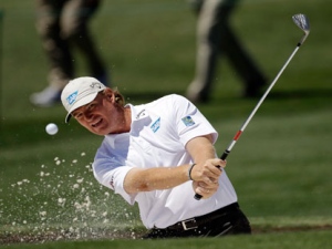 Ernie Els of South Africa hits out of a bunker on the second hole during a practice round the Masters golf tournament Wednesday, April 6, 2011, in Augusta, Ga. (AP Photo/Dave Martin)