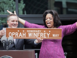 In one of his last acts before leaving office next week, Chicago Mayor Richard M. Daley presents TV talk-show host Oprah Winfrey with a sign after a street was named in her honor outside her Harpo Studios in Chicago, Wednesday, May 11, 2011. Winfrey will end her 25 year-run on daytime television in Chicago on May 25. (AP Photo/M. Spencer Green)