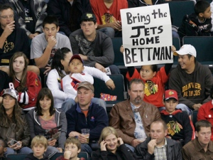 A child holds up a sign during the first period of the pre-season NHL game between Tampa Bay Lightning and Chicago Blackhawks in Winnipeg on Wednesday, September 22, 2010. (THE CANADIAN PRESS/John Woods)