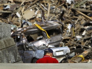 A man steps down stairs in an area devastated by the March 11 earthquake and tsunami in Kesennuma, Miyagi Prefecture, northeastern Japan, Thursday, May 19, 2011. (AP Photo/Junji Kurokawa)  