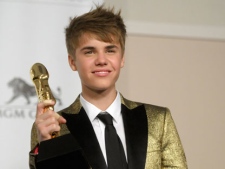 Singer Justin Bieber poses in the press room at the 2011 Billboard Music Awards in Las Vegas on Sunday, May 22, 2011. (AP Photo/Dan Steinberg)