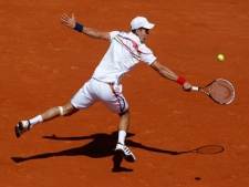 Novak Djokovic of Serbia returns the ball to Thiemo de Bakker of The Netherlands during the first round match of the French Open tennis tournament at Roland Garros stadium in Paris, Monday May 23, 2011. (AP Photo/Christophe Ena)