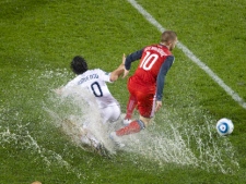 Toronto FC's Alen Stevanovic, right, takes the ball away from Vancouver Whitecaps' Davide Chiumiento during a waterlogged second half Nutrilite Canadian Championship final second leg action in Toronto on Wednesday May 25, 2011. (THE CANADIAN PRESS/Chris Young)