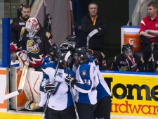 Kootenay Ice teammates celebrate their empty net goal in front of the Owen Sound Attack's bench during third period Memorial Cup hockey action in Mississauga, Ont., on Thursday, May 26, 2011. (THE CANADIAN PRESS/Nathan Denette)