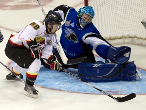 Saint John Sea Dogs goaltender Jacob DeSerres makes a save on Owen Sound Attack forward Mike Halmo (28) during first period Memorial Cup action in Mississauga, Ontario, on Monday, May 23, 2011. (THE CANADIAN PRESS/Frank Gunn)