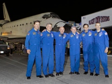 The crew of space shuttle Endeavour, from left, European Space Agency astronaut Roberto Vittori, of Italy, British born U.S. astronaut, pilot Greg Johnson, commander Mark Kelly, mission specialist Mike Fincke, Canadian born U.S. astronaut Greg Chamitoff and mission specialist Drew Feustel gather for a photo after landing at the Kennedy Space Center in Cape Canaveral, Fla., Wednesday, June 1, 2011.(AP Photo/John Raoux, Pool)