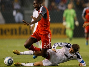 Toronto FC's Tony Tchani (22) is fouled by Los Angeles Galaxy midfielder David Beckham (23) during the first half of an MLS soccer match in Carson, Calif., Saturday, June 11, 2011. (AP Photo/Lori Shepler)