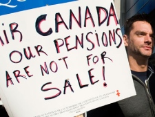 An Air Canada customer service agent pickets outside Pierre Elliott Trudeau airport in Montreal Tuesday, June 14, 2011 after walking off the job following failed negotiations between union's and management on pension reform issues. (THE CANADIAN PRESS/Graham Hughes)