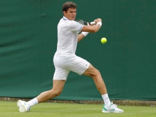 Canada's Milos Raonic plays a return shot to Tunisia's Marc Gicquel at the All England Lawn Tennis Championships at Wimbledon, Monday, 20 June, 2011. (AP Photo/Anja Niedringhaus)