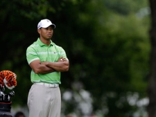 In this July 2, 2010, file photo, Tiger Woods waits to hit during the second round of the AT&T National golf tournament at the Aronimink Golf Club in Newtown Square, Pa. Woods will miss another golf tournament as he recovers from injuries to his left leg, saying Wednesday, June 22, 2011, he will not play in the AT&T National next week outside Philadelphia. (AP Photo/Rob Carr)